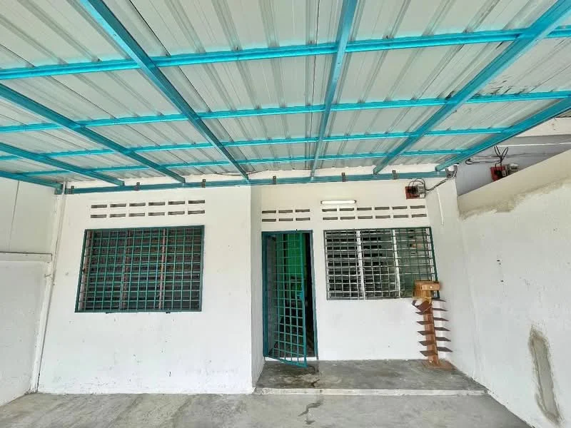 Exterior features: metal roof with blue trusses, white painted walls, grilled windows, green door, concrete flooring, exposed electrical wiring, vertical wooden slats, open space, front entrance; style: modern.