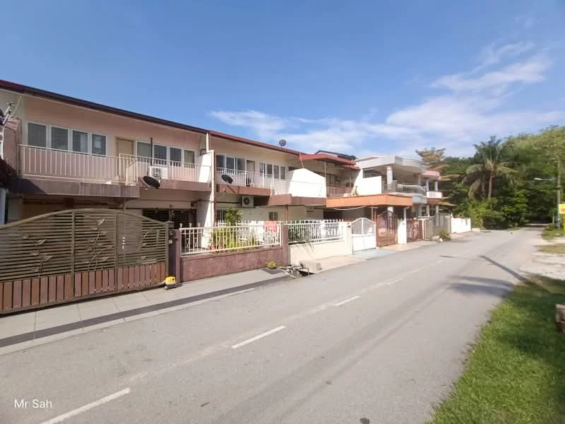 Exterior type: linked terrace house; features: two-storey building, balconies on upper floor, white painted facade, red tiled roof, metal gate, front garden area, driveway, paved walkway, surrounded by greenery, street view, multiple air conditioning units visible; style: modern.
