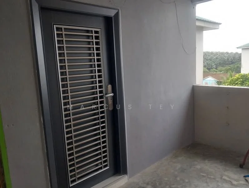 Room features: grey painted walls, concrete flooring, metal security door with slats, door handle, light fixture, corner of a building, outdoor balcony space.