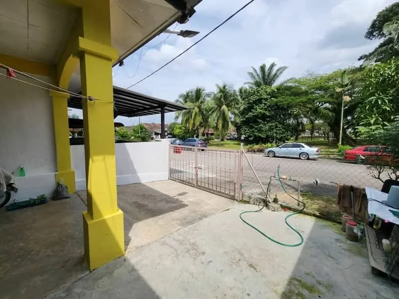 Exterior type: linked terrace house; features: yellow painted facade, concrete flooring, fenced perimeter, gate at entrance, manicured landscaping, palm trees, driveway, street view, outdoor hose, covered porch area; style: modern.