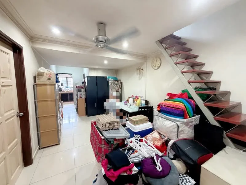 Room features: white painted walls, glossy tile flooring, 5-blade ceiling fan with light, wooden staircase, wall clock, storage shelves, various boxes and items stacked, open layout leading to kitchen area; style: modern.