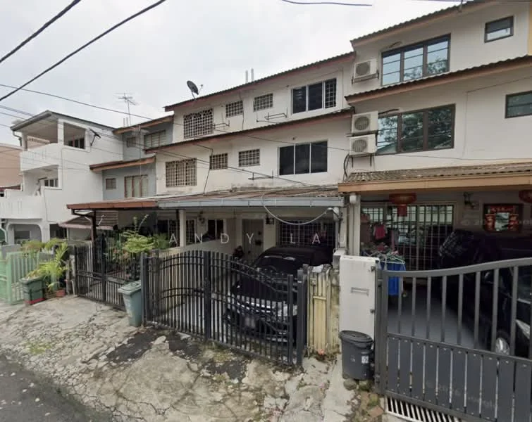 Exterior type: linked terrace house; features: two-storey building, white painted facade, brown tiled roof, multiple air conditioning units visible, gated entrance, black metal gate, driveway with parked cars, front garden with plants, visible utility poles and wires, surrounded by residential area; style: modern.
