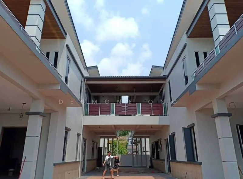 Exterior type: linked terrace house; features: two-storey building, cream painted facade, wooden balcony railings, flat roof, open courtyard, multiple entrances, large windows, exposed concrete, manicured landscaping, surrounded by greenery; style: modern.