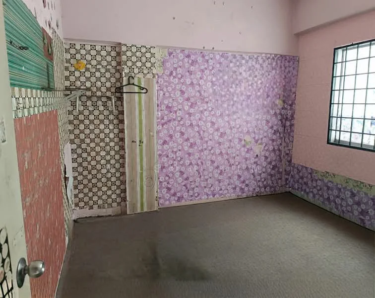Room features: pink painted walls, floral wallpaper, checkered wallpaper, carpet flooring, window with metal bars, hanging clothes rack, door with simple design.