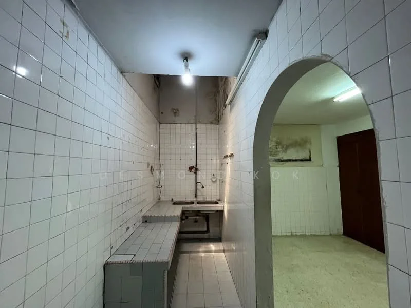 Kitchen features: white tiled walls, white tiled flooring, single-bowl stainless-steel sink, metal countertop, fluorescent ceiling light, open layout, archway entrance, no visible cabinetry, no visible appliances. Room features: white tiled walls, white tiled flooring, fluorescent ceiling light, archway entrance.