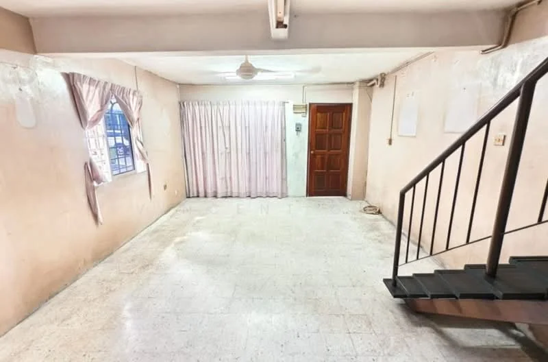 Living features: cream painted walls, marble tile flooring, ceiling fan, window with sheer curtains, wooden door, staircase with metal railing, curtains, light switch, baseboard, no visible furniture.