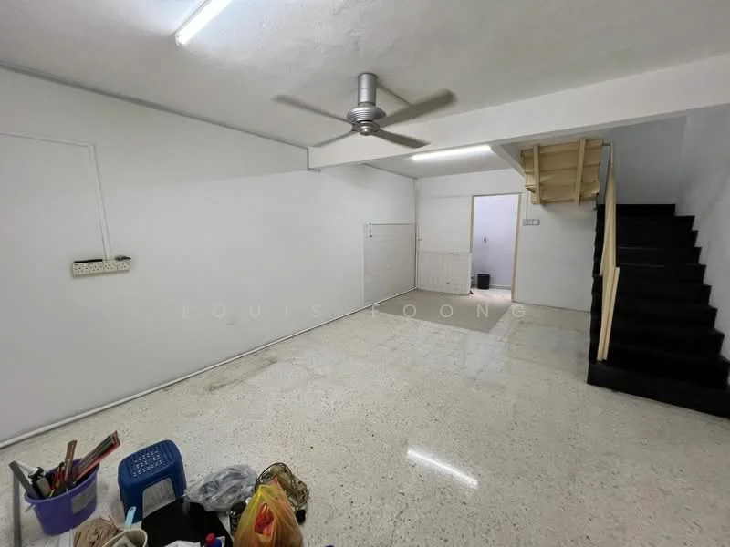 Room features: white painted walls, polished concrete flooring, 5-blade ceiling fan, staircase leading to upper level, doorway leading to another room, open space layout, no visible furniture, lighting fixtures on ceiling; style: minimalist.