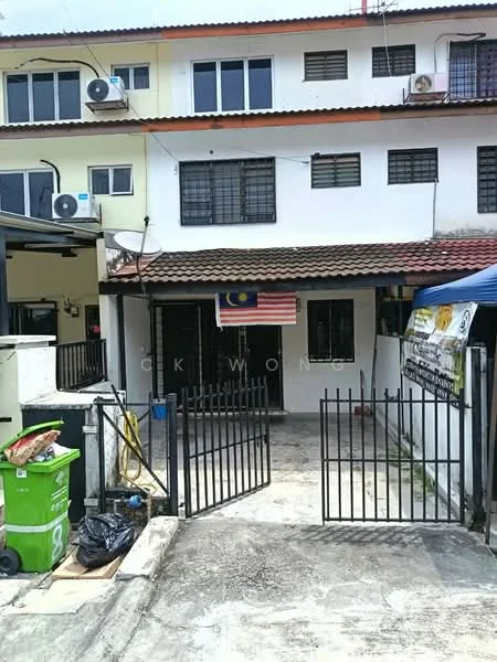 Exterior type: linked terrace house; features: two-storey building, red tiled roof, white painted facade, black wrought iron gate, concrete driveway, visible air conditioning units, Malaysian flag, fenced yard, outdoor signage, manicured lawn; style: modern.