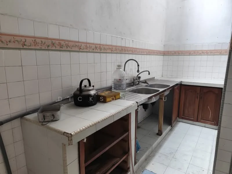 Kitchen features: double-bowl stainless-steel sink, chrome pull-down faucet, white tiled backsplash with floral pattern, white tiled walls, white tiled flooring, wood cabinetry with brown finish, open shelving, kettle, water bottle, storage area under counter.