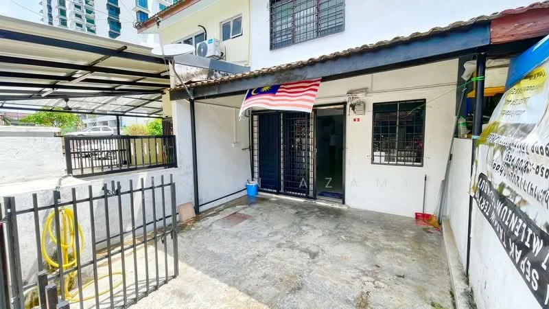Exterior type: linked terrace house; features: white painted facade, flat roof, metal gate, concrete flooring, Malaysian flag, fenced yard, outdoor space, visible air conditioning unit, surrounded by greenery; style: modern.