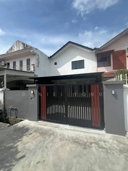 Exterior type: detached bungalow; features: black metal gate, grey painted facade, white walls, pitched roof, overhang roof, driveway with concrete surface, landscaped front yard, visible neighboring houses; style: modern.