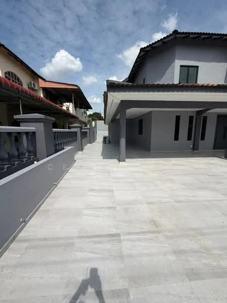Exterior type: semi-detached house; features: grey tiled flooring, concrete walls, gabled roof, driveway, manicured landscaping, outdoor space with ample sunlight, multiple windows, covered car porch, fence along the perimeter, clear blue sky; style: modern.