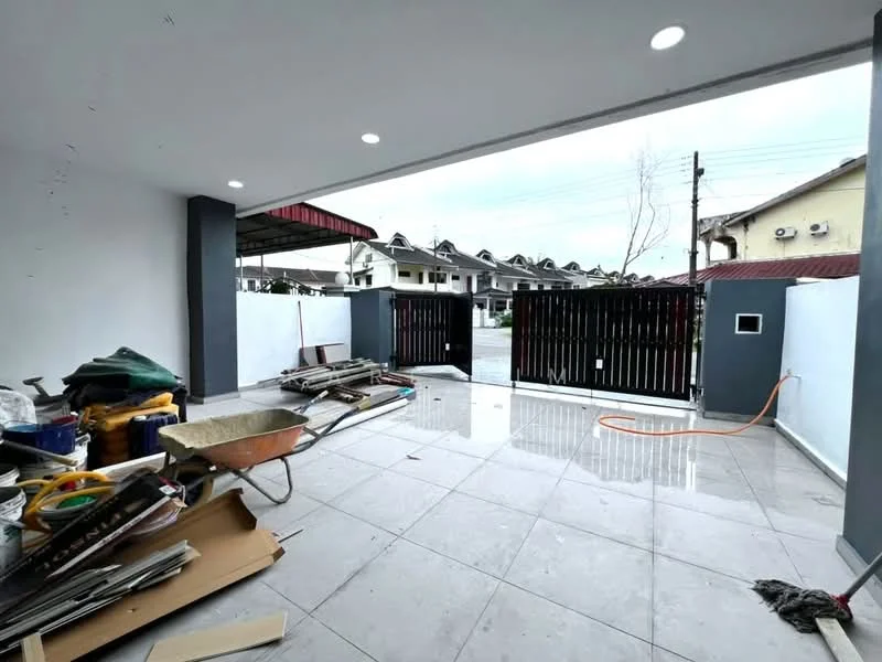Exterior features: paved flooring, black wooden gate, concrete walls, overhead lighting, open space, surrounding residential buildings, wet surface, construction materials visible; style: modern.