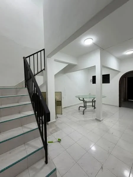 Room features: white painted walls, white ceiling, recessed ceiling lights, staircase with black metal railing, glossy white tile flooring, glass dining table, open space layout, corner with archway leading to another room; style: modern.