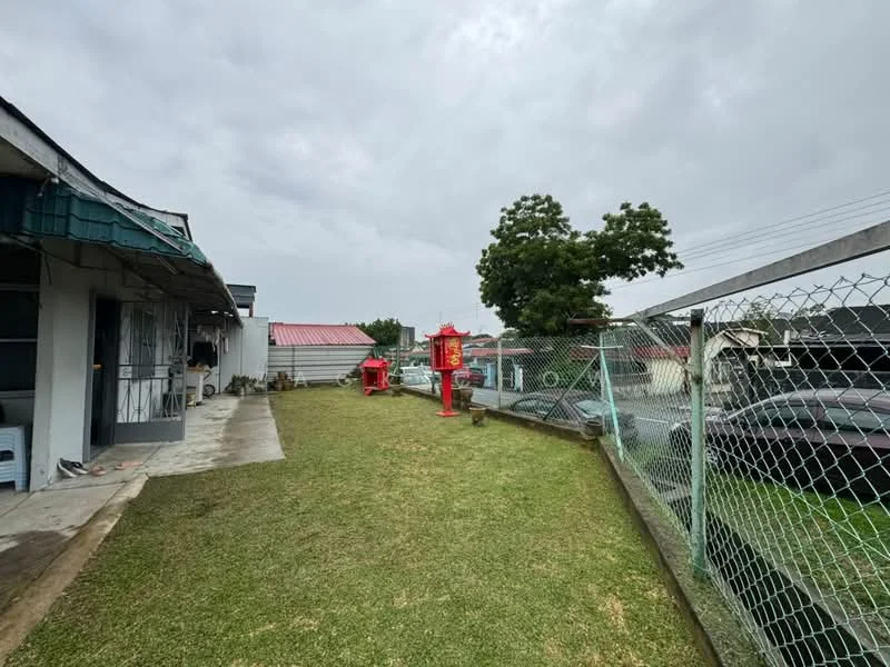 Exterior type: detached bungalow; features: manicured lawn, fenced yard, outdoor decorative elements, single-storey structure, concrete pathway, surrounding greenery, car parking area; style: traditional.