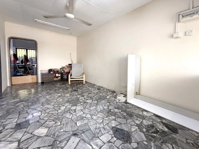 Room features: grey stone flooring, white painted walls, ceiling fan, mirror, wooden dresser, stacked storage boxes, light-colored armchair, natural light from window; style: minimalist.
