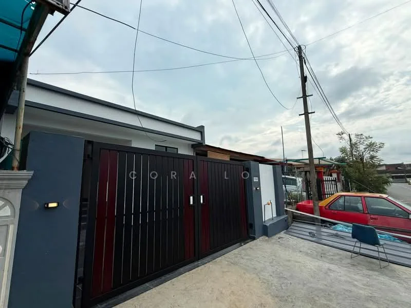 Exterior features: red and black metal gate, concrete driveway, grey painted facade, single-storey building, overhead power lines, surrounding greenery, paved walkway, parking space for one car; style: modern.