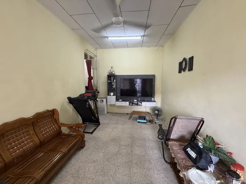 Living features: cream painted walls, ceiling with fluorescent lights, tile flooring, 3-seater wooden sofa, 2-seater wooden sofa, wall-mounted TV, TV console, fan, exercise machine, decorative wall art, window with curtain, area rug.