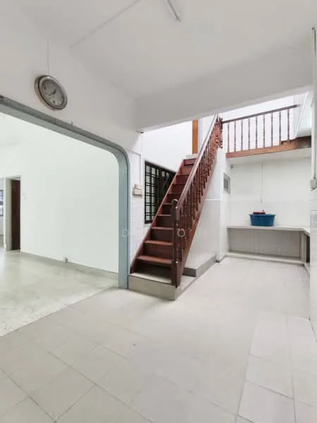 Room features: staircase with wooden railing, white painted walls, tile flooring in light grey, ceiling light fixture, open space layout, large window for natural light, wall clock, built-in cabinetry, sink area with countertop; style: modern.