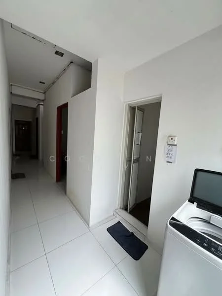Room features: white painted walls, white tiled flooring, doorway leading to another room, laundry area with washing machine, single door, narrow hallway, light fixture on ceiling, mat at entrance.