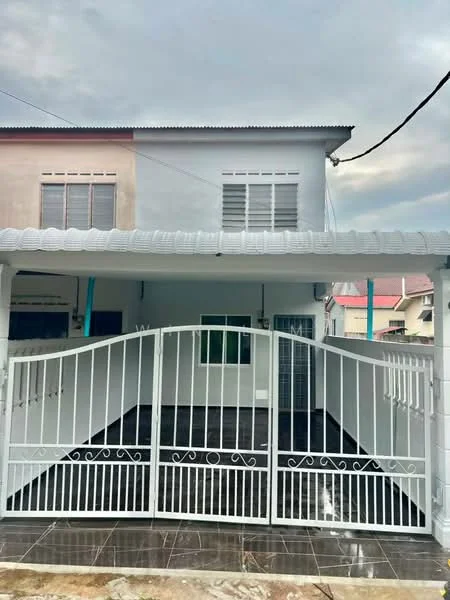 Exterior type: linked terrace house; features: white painted facade, flat roof, double-storey, manicured lawn, paved driveway, metal gate, windows with grilles, porch area, surrounded by residential buildings; style: modern.