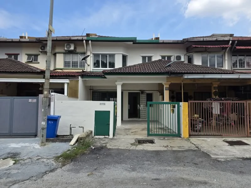 Exterior type: linked terrace house; features: white painted facade, brown tiled roof, front porch with concrete flooring, metal gate, green door, two-storey structure, air conditioning units visible, manicured lawn, driveway with gravel, surrounded by neighboring houses; style: modern.