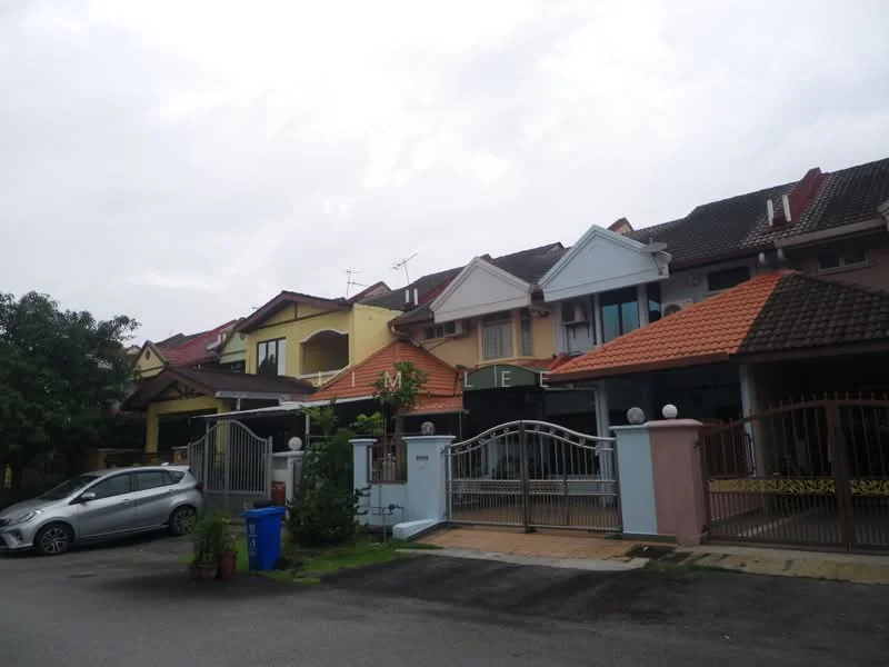 Exterior type: linked terrace house; features: multi-storey, red tiled roof, cream painted facade, white gate, driveway with interlocking pavers, manicured lawn, surrounded by greenery, front porch, balconies on upper floors, visible car parking area; style: modern.