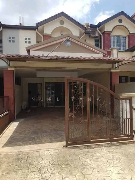 Exterior type: linked terrace house; features: brown painted facade, red brick accents, pitched tile roof, decorative wrought iron gate, stone-paved driveway, covered car porch, two-storey structure, windows with grilles, manicured landscaping; style: modern.