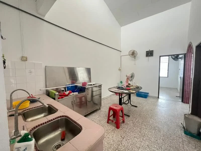 Kitchen features: double-bowl stainless-steel sink, chrome pull-down faucet, stainless-steel countertop, white tiled backsplash, red plastic stools, round dining table, ceiling fan, exposed beams, grey speckled flooring, wall-mounted fan, open layout.