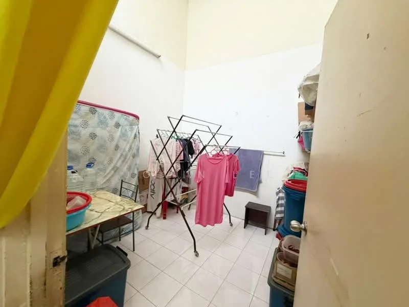 Laundry features: white painted walls, white tile flooring, clothes drying rack, folding table, plastic storage bins, stacked laundry baskets, hanging clothes, door with handle.