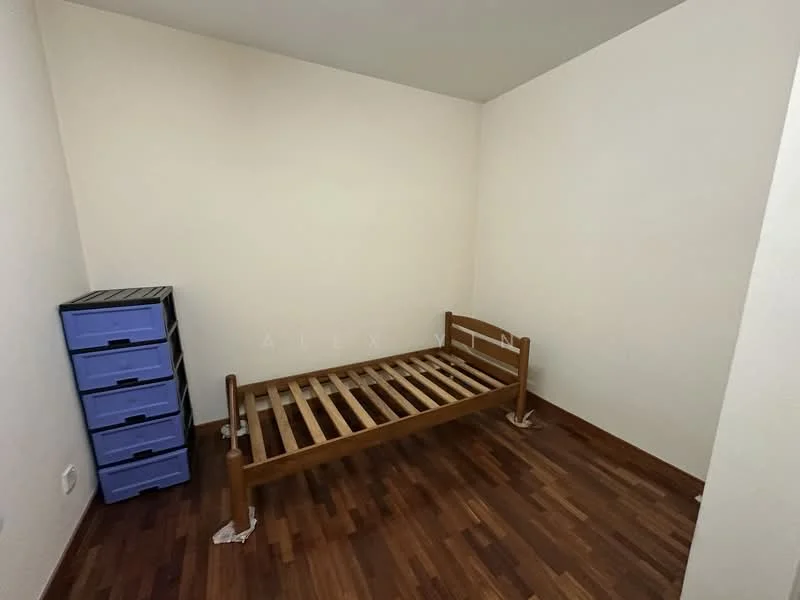 Bedroom features: single bed frame, wooden flooring, white painted walls, plastic storage drawers in blue, corner layout, no visible window treatments.