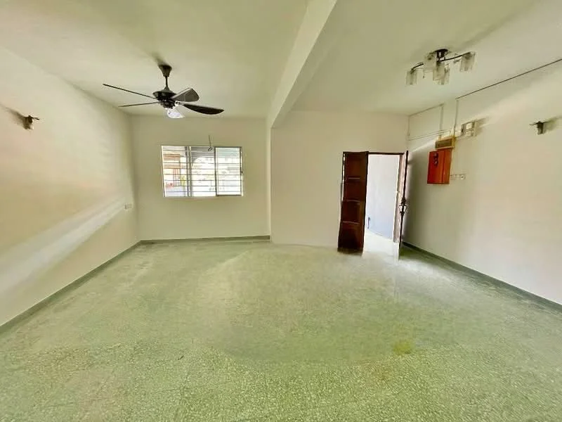 Living features: green terrazzo flooring, white painted walls, ceiling fan, 2-light ceiling fixture, window with grille, wooden door, door frame, corner wall sconce.