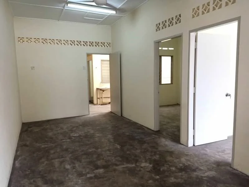 Room features: plain white walls, concrete flooring, ceiling fan, multiple doorways, window with natural light, decorative wall vents, neutral color scheme, no visible furniture; style: minimalist.