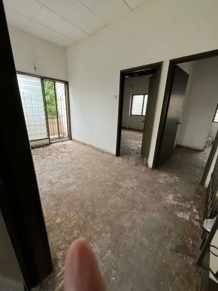 Room features: bare concrete flooring, white painted walls, two doors leading to separate rooms, large window with metal grille, exposed ceiling, no visible furniture or fixtures.
