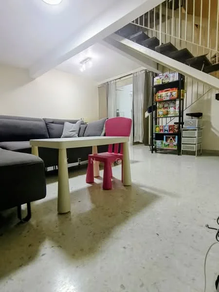 Living features: grey fabric sectional sofa, white coffee table, laminate flooring, recessed downlights, staircase with railing, wall-mounted shelving unit, decorative cushions, curtains, open layout; style: modern.