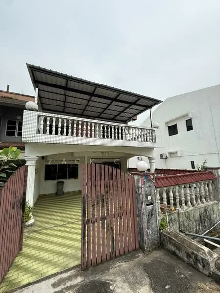 Exterior type: detached bungalow; features: covered porch with metal roofing, white painted facade, balustrade railing, red tiled roof, green tiled flooring, wooden gate, exposed concrete wall, manicured garden area, parking space, surrounded by greenery; style: traditional.