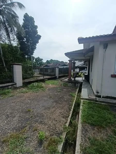 Exterior type: detached bungalow; features: single-storey building, paved walkway, manicured lawn, fenced perimeter, tropical landscaping, gutter along the side, roof overhang, driveway, adjacent residential area; style: modern.
