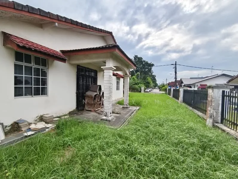 Exterior type: detached bungalow; features: white painted facade, red tiled roof, front porch with columns, overgrown grass, concrete pathway, fenced yard, visible neighboring houses, cloudy sky; style: traditional.