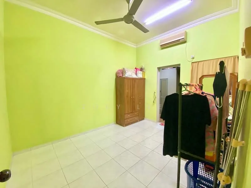 Room features: green painted walls, white ceiling with crown moulding, ceiling fan, wall-mounted air conditioning unit, white tiled flooring, built-in wardrobe with wooden finish, full-length mirror, clothes rack, window with curtain, decorative items on top of wardrobe.
