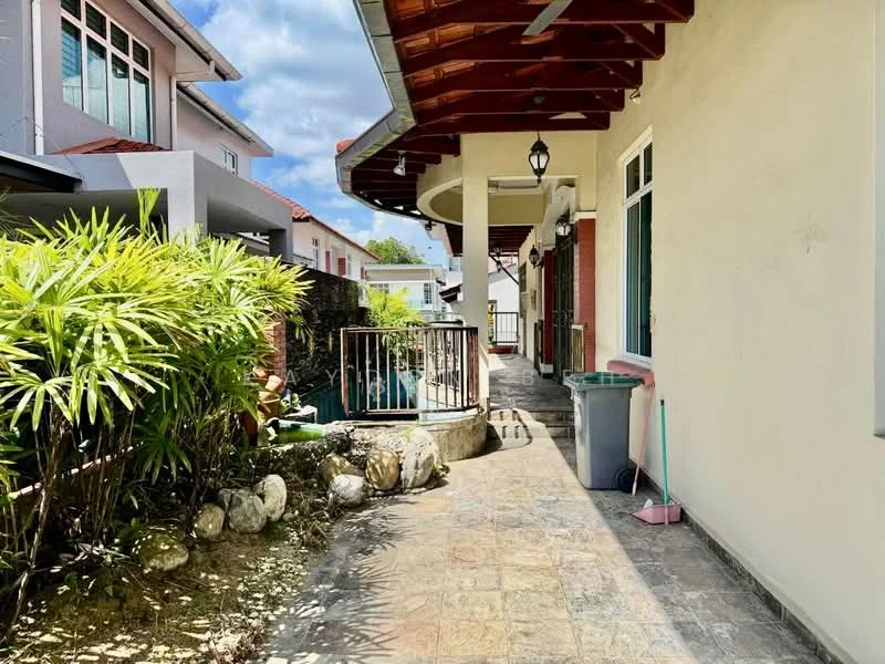 Exterior type: detached bungalow; features: stone-paved walkway, manicured garden with tropical plants, white painted facade, red tiled roof, covered porch area, balcony railing, outdoor light fixture, green trash bin, garden hose, decorative rocks; style: modern.