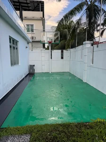 Exterior features: basketball court, green synthetic flooring, surrounded by white walls, paved area, manicured lawn, palm trees in background; style: modern.