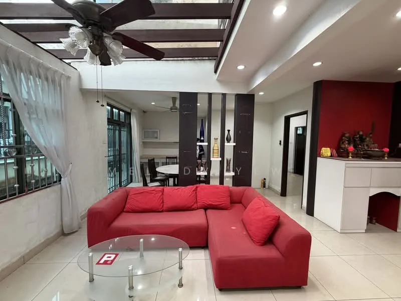 Living features: red L-shape sectional sofa, glass coffee table, ceiling fan with light, white walls, tile flooring, large windows with metal grills, decorative wall with black panels, dining area visible in background, decorative items on console table; style: modern.