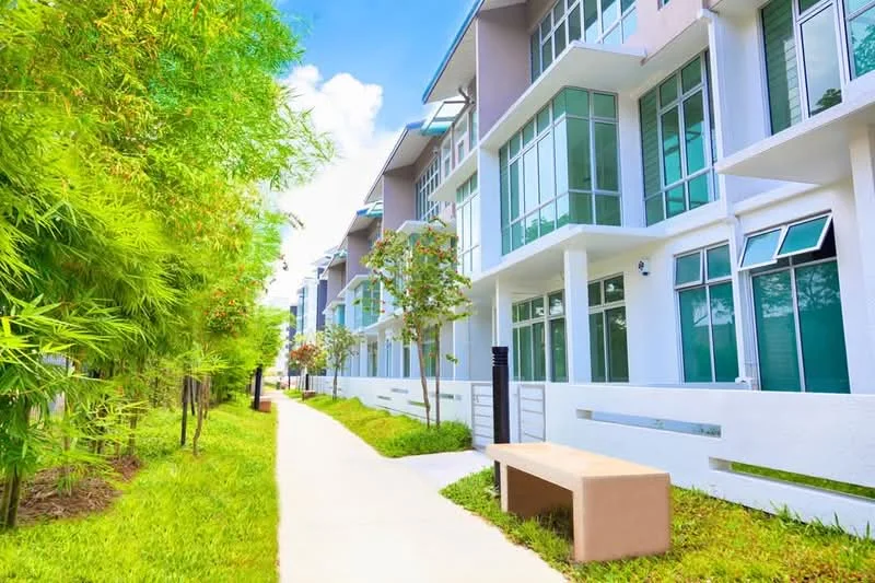 Exterior type: linked terrace house; features: white painted facade, large glass windows, green landscaping with bamboo, manicured lawn, concrete pathway, outdoor bench, modern architectural design; style: modern.