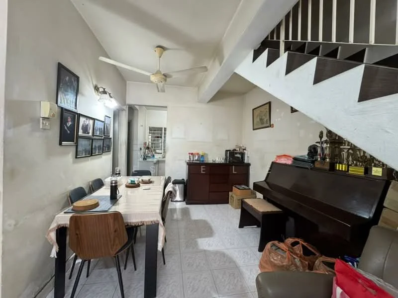 Dining features: dining table with 4 chairs, ceiling fan, white painted walls, tile flooring, wooden sideboard, piano, framed artwork on walls, staircase leading to upper floor, natural light from nearby window, decorative items on sideboard.