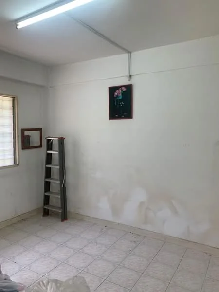 Room features: white painted walls, tile flooring, window with blinds, ladder, framed artwork on wall, visible wall stains.