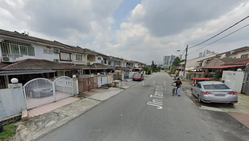 Exterior type: linked terrace house; features: two-storey linked terrace houses, white painted facade, red tiled roof, manicured lawns, driveways with interlocking pavers, street lined with trees, visible street signage, surrounded by residential area, parking spaces in front of houses; style: modern.