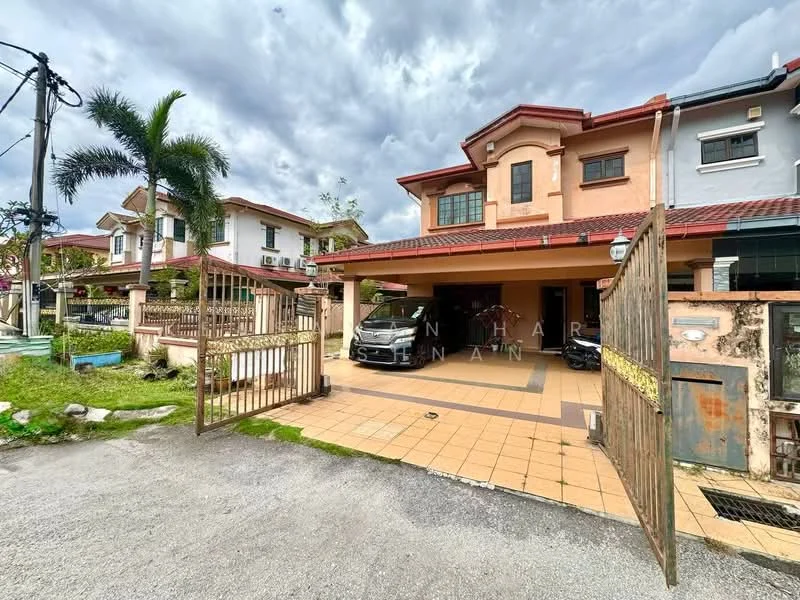 Exterior type: semi-detached house; features: gated entrance, paved driveway, car porch, two-storey structure, red tiled roof, cream painted facade, manicured lawn, palm trees, surrounded by greenery, adjacent houses visible; style: modern.