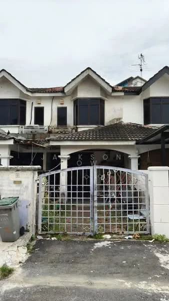 Exterior type: linked terrace house; features: two-storey building, white painted facade, pitched tile roof, black framed windows, metal gate, front yard with overgrown grass, visible outdoor seating area, satellite dish on roof, walled perimeter, driveway, exposed brick wall, decorative window shutters; style: traditional.