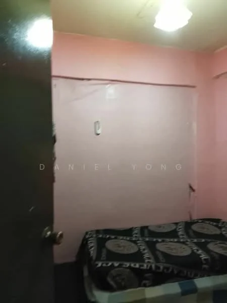 Room features: pink painted walls, single bed, bedspread with geometric pattern, light fixture on ceiling, door with knob, window with no visible treatment.