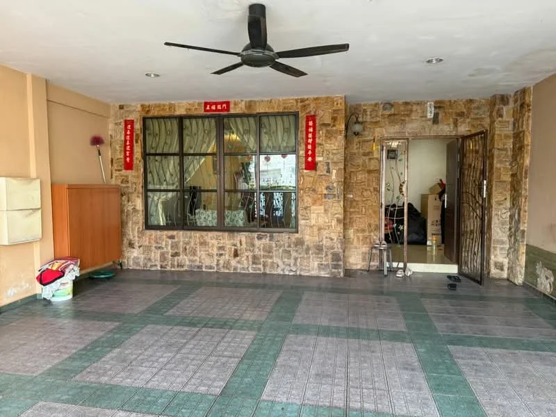 Room features: exposed stone wall, grey tiled flooring, green tiled border, ceiling fan, large window with curtains, wooden cabinet, doorway leading to another room, decorative wall hangings; style: modern.